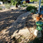 This image depicts the curved pathway made from decomposed granite with flag stone pavers.