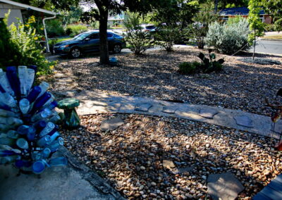 An image of a blue bottle tree which is to the right of the front door.