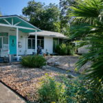 This is another view of the front yard with river rock, lantana, and various sages.