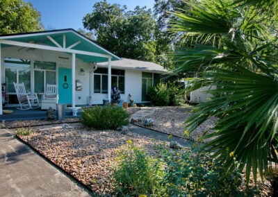 This is another view of the front yard with river rock, lantana, and various sages.