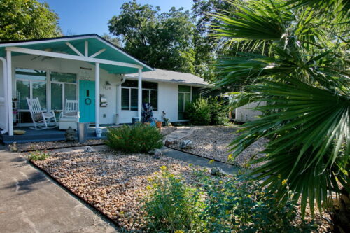 This is another view of the front yard with river rock, lantana, and various sages.