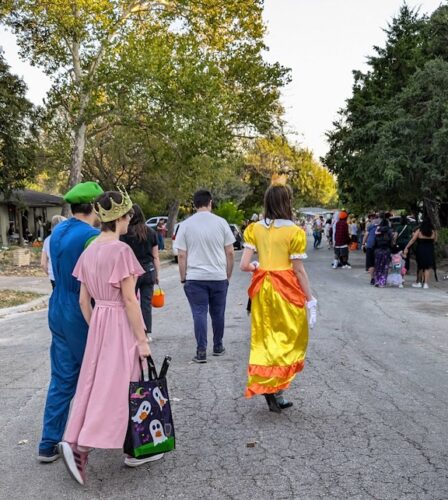 Hundreds of trick-or-treaters in costume on Peggy Street